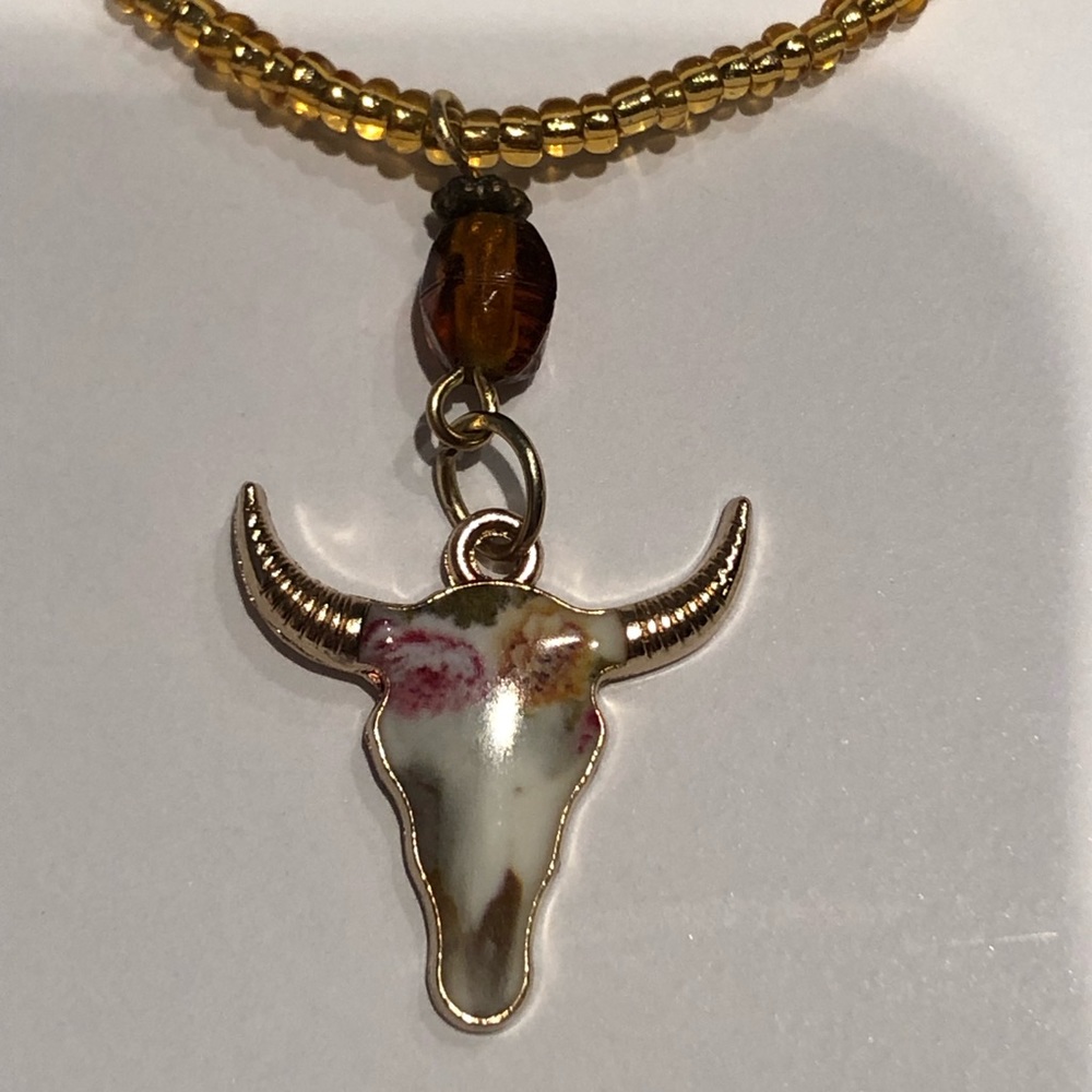 Handmade gold seed-bead, stretch necklace with boho cow skull pendant